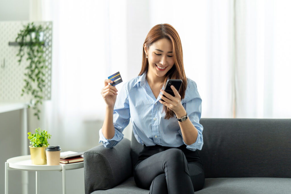 woman making online purchase with credit card and mobile phone